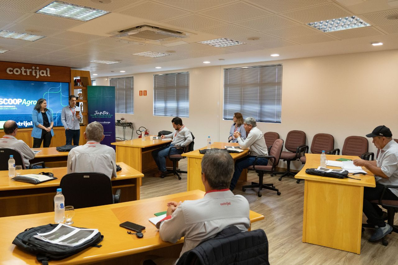 Instrutora conduz formação com conselheiros fiscais da Cotrijal, em sala com mesas distribuídas em grupos e materiais de apoio. Foto: Raíza Goi Borba | Cotrijal 